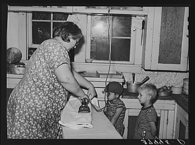 Mrs. J. Webster ironing while her sons look on. Tehama County California
